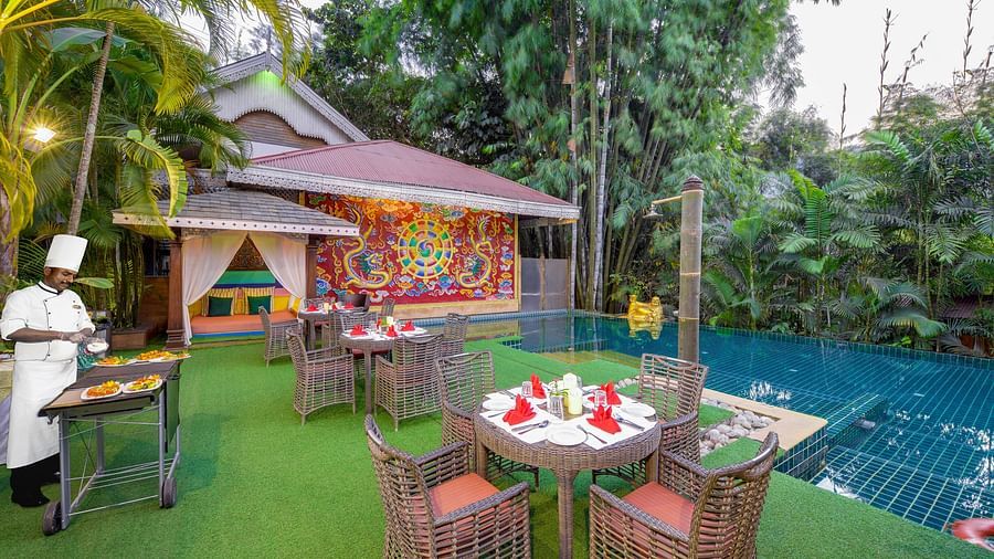 seating space and a barbecue set-up by the pool - Mayfair Spa Resort & Casino Gangtok 
