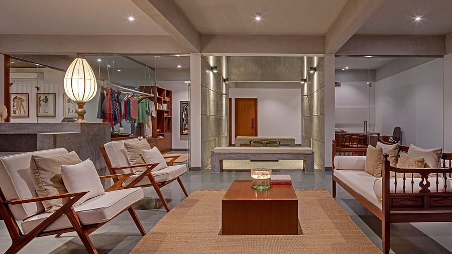 Living room with wooden furniture, rug, and decorative items, spacious interior - Shreyas Retreat