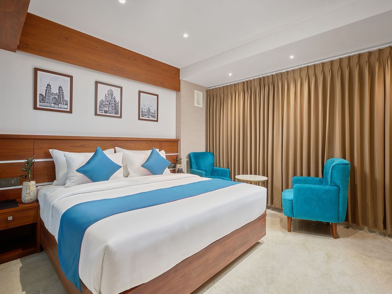Image of the premium room featuring a king size bed along with a seating set up at the corner.