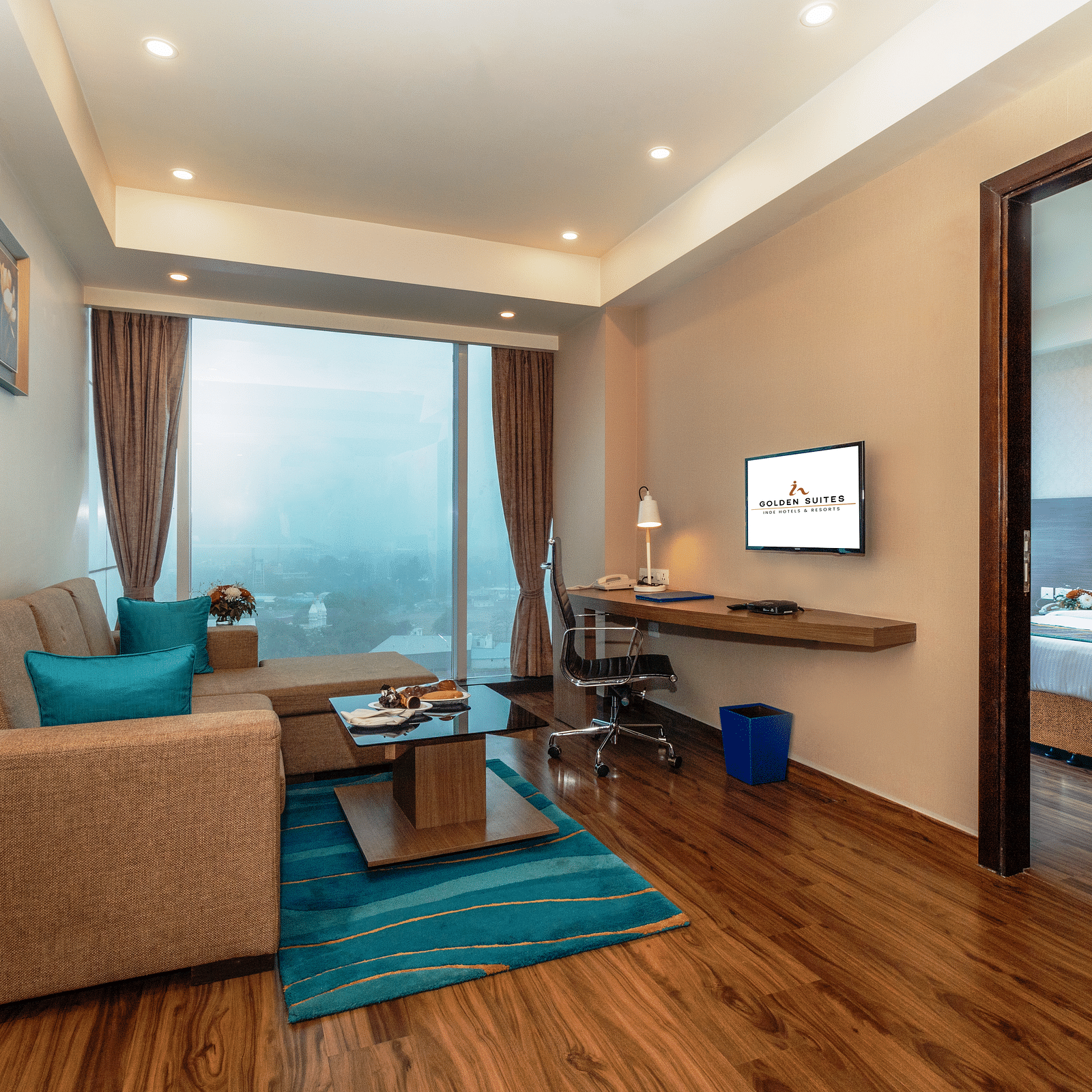 A corner view of the living room along with the bedroom at glden suite
