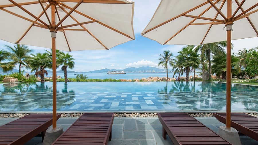 A pool side view of our resort on a sunny day - Alibu Resort Nha Trang
