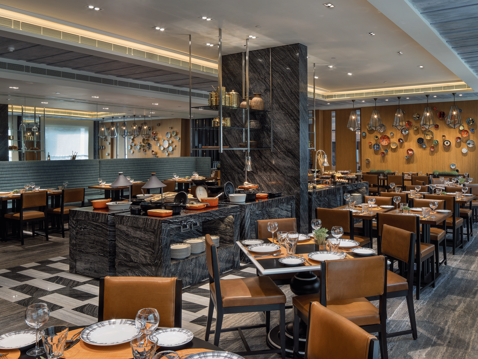 A vibrant dining room with contemporary decor, cushioned chairs, tables with cutlery arranged over them and a welcoming atmosphere at The Raintree, St. Mary's Road.