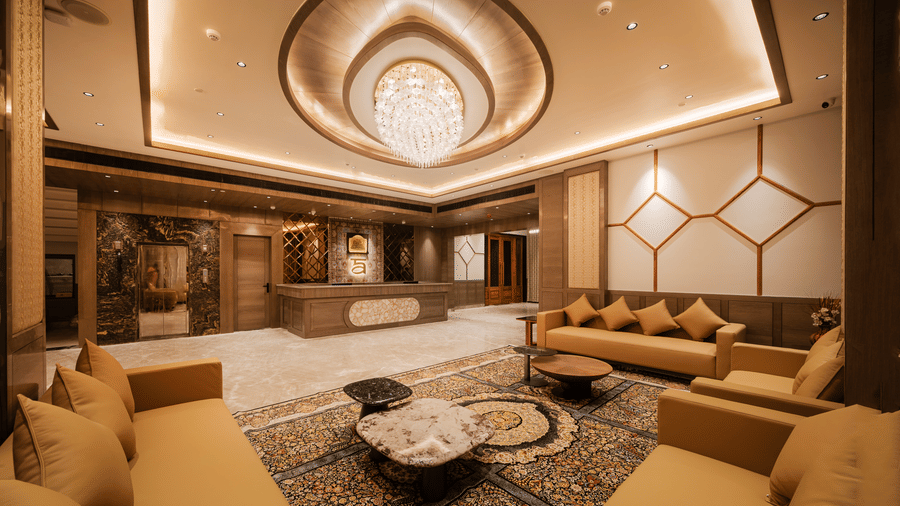 A spacious waiting lounge with plush tan sofas, patterned rugs, and elegant ceiling fixtures at Ananta Express, Katra.