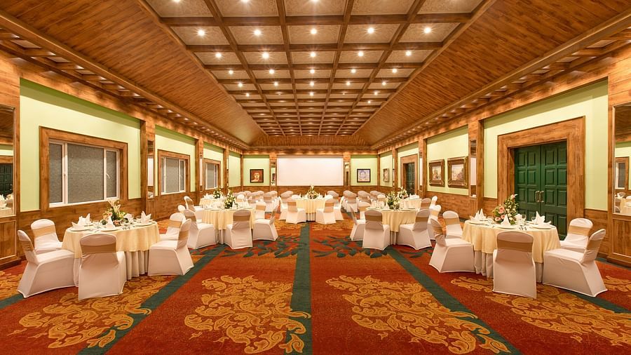 a frontal view of the indoor seating space of Everest, a banquet hall - Mayfair Himalayan Spa Resort Kalimpong 