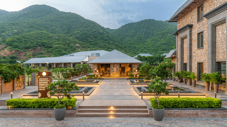 Grand entrance pavilion with stone pathway, water features, and traditional architecture at Pushkara Resort & Spa, Ajmer