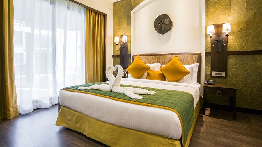 an overview of a room with clean sheets and pillows on it inside one of the rooms - Rhythm Lonavala