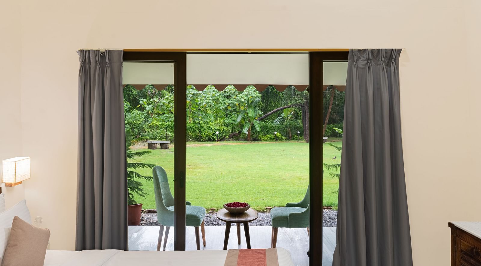 image of the lush green lawn from the balcony of one of the bedrooms of luxury family suite at aranya vilas in udaipur