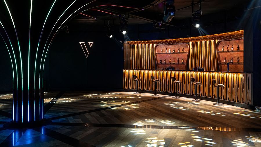 Verve featuring a wooden stage and decorative lighting at The Qualia Resort Club & Brewery, Udaipur.