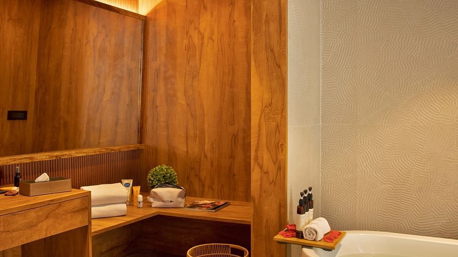 Image of the bathroom of Coral Teal Suite at Coral Reef Resort and Spa in Havelock featuring the bathtub with toiletries placed next to it along with bath towels