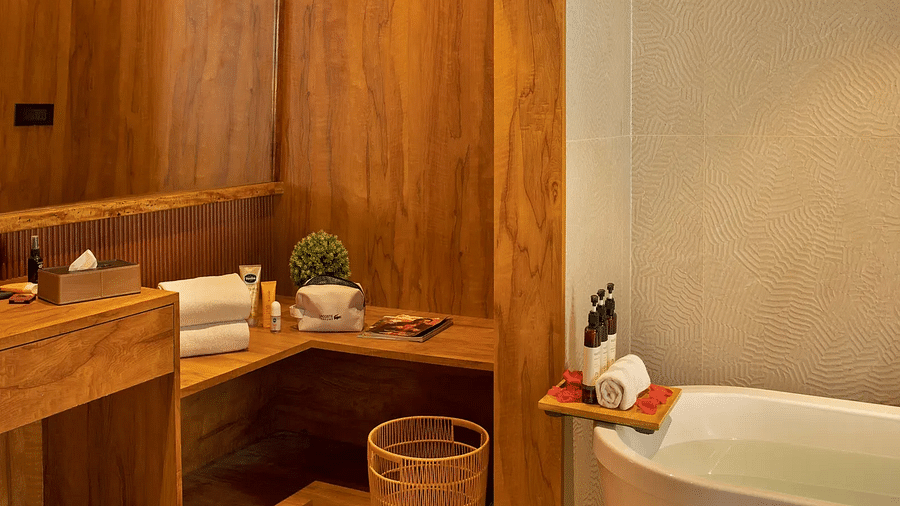 Image of the bathroom of Coral Teal Suite at Coral Reef Resort and Spa in Havelock featuring the bathtub with toiletries placed next to it along with bath towels