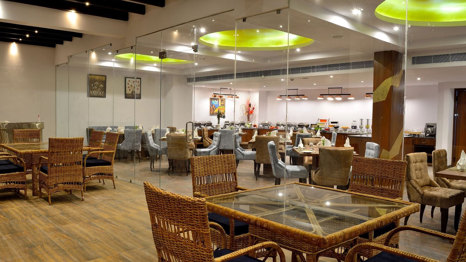 Spacious restaurant with wooden tables and chairs, bright lighting, inviting ambience.