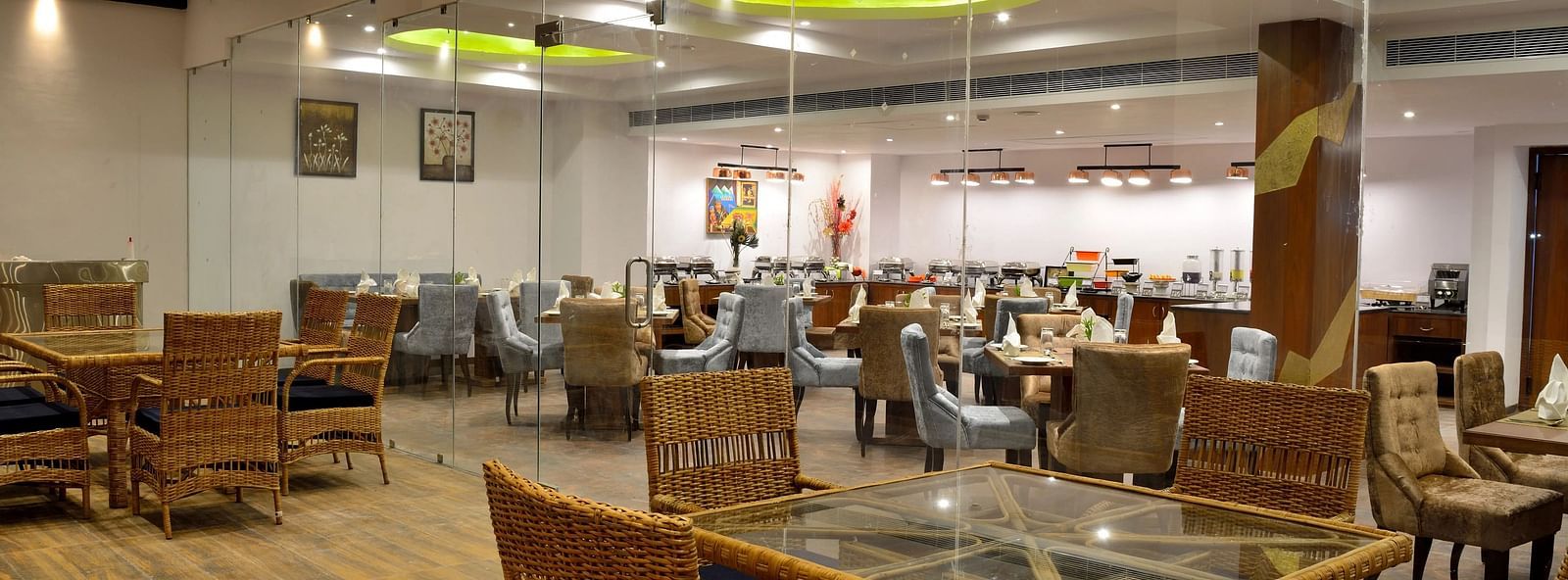 Spacious restaurant with wooden tables and chairs, bright lighting, inviting ambience.