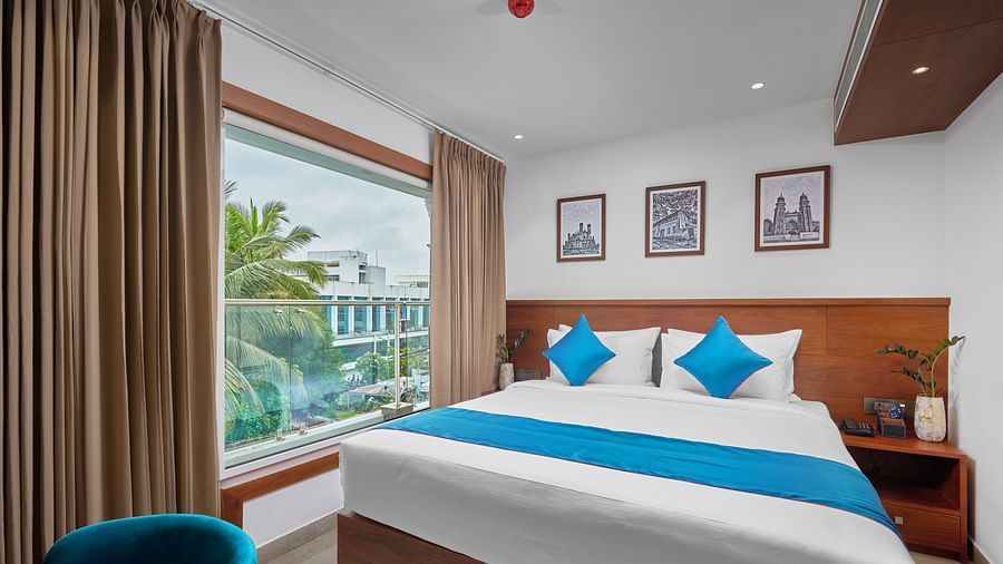 Image of the superior room with a expansive room and sofa along with king size bed.