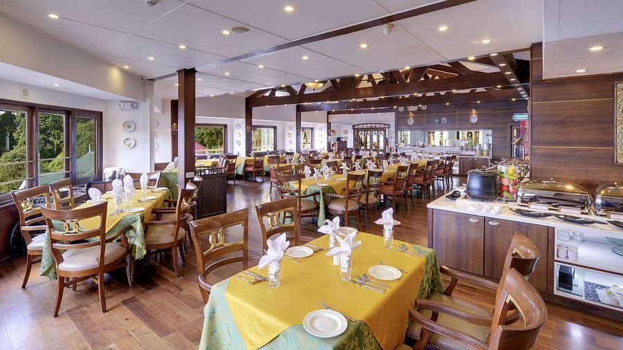 indoor seating space at the restaurant - Mayfair Hill Resort, Darjeeling 3