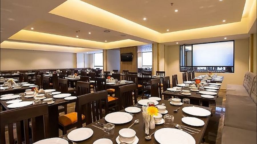 An image of a restaurant with chairs, tables and crockery and utensils are laid out on the table - Yashshree Sanderling, Darjeeling