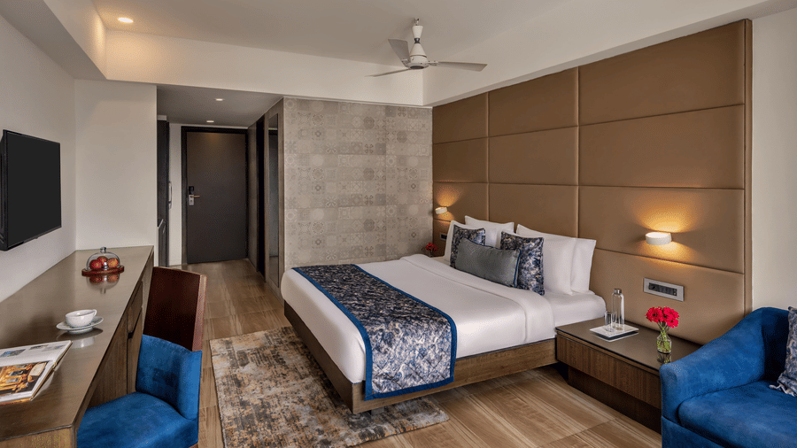 Guest room with double bed and seating area at Voyage Milestone Hotel and Banquet.
