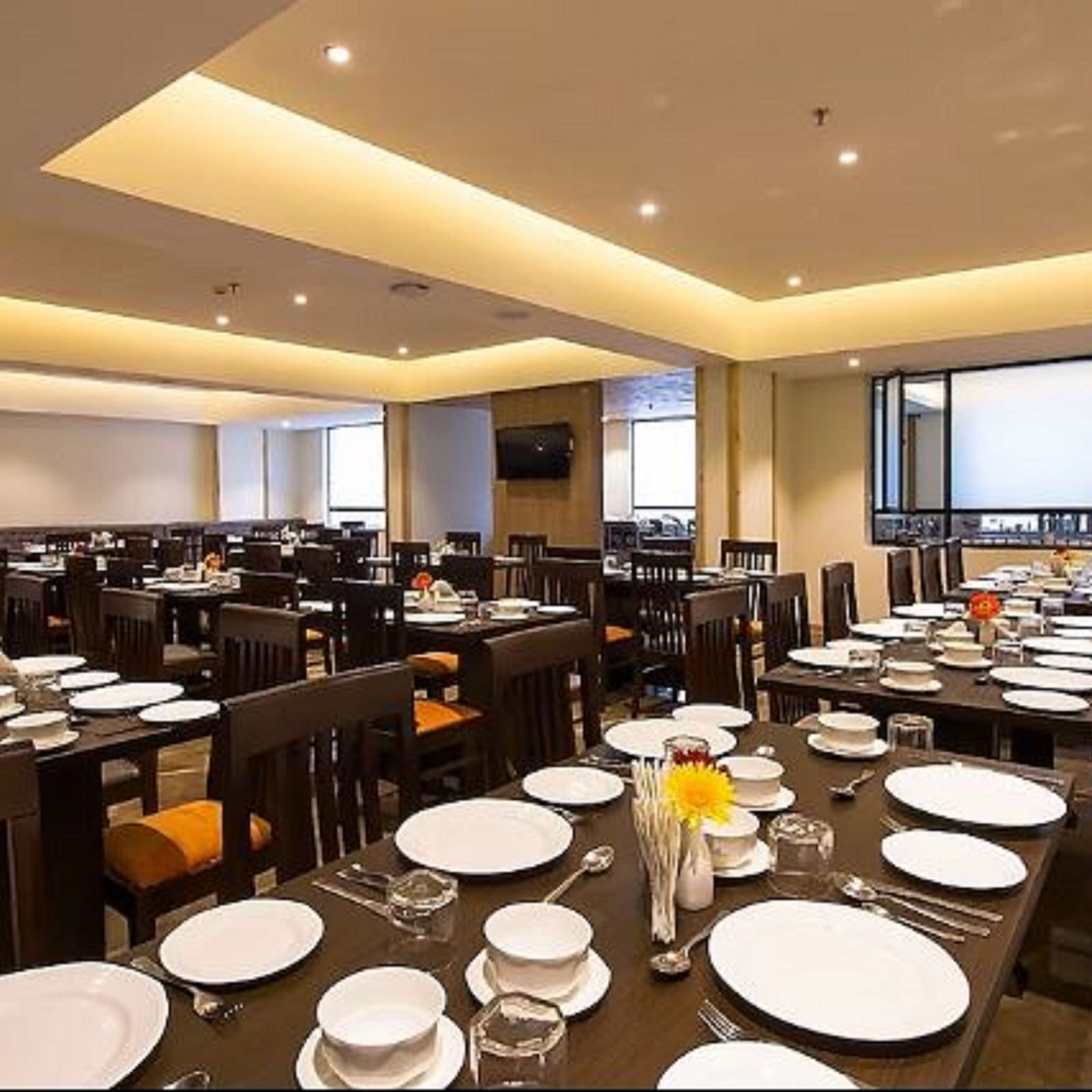 An image of a restaurant with chairs, tables and crockery and utensils are laid out on the table - Yashshree Sanderling, Darjeeling
