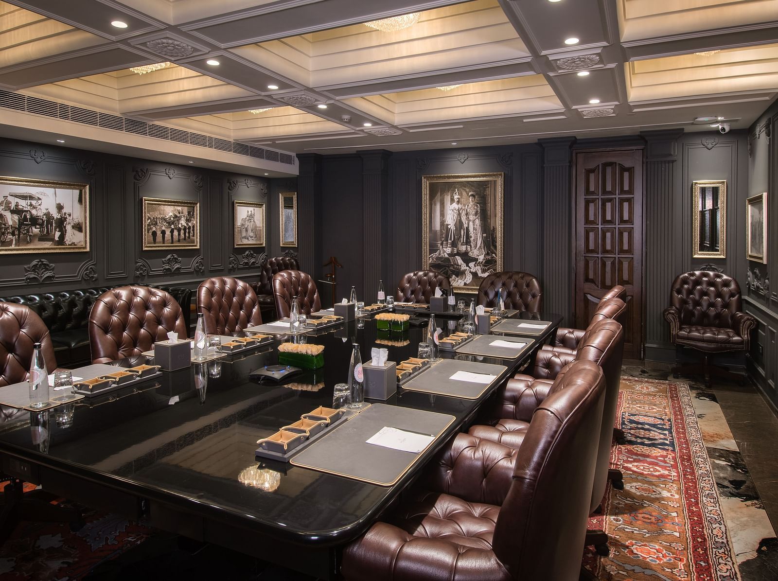 an expnsive image of the king george V board room with black coloured table top - The Claridges New Delhi