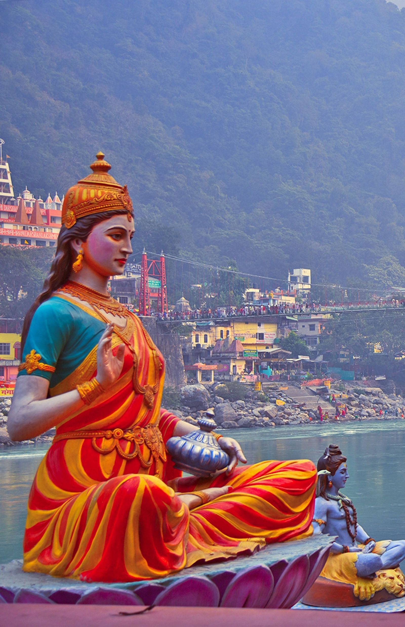 Image of statues of  gods and goddess by a river bank