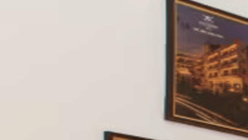 A spacious comfy room with 3 plushy bed, posters on wall, an open window at Max Hotel Prayagraj.