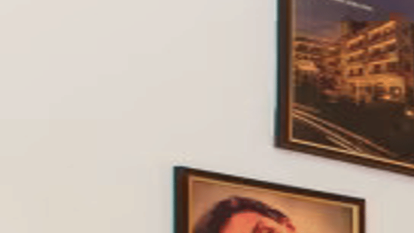 A spacious comfy room with 3 plushy bed, posters on wall, an open window at Max Hotel Prayagraj.