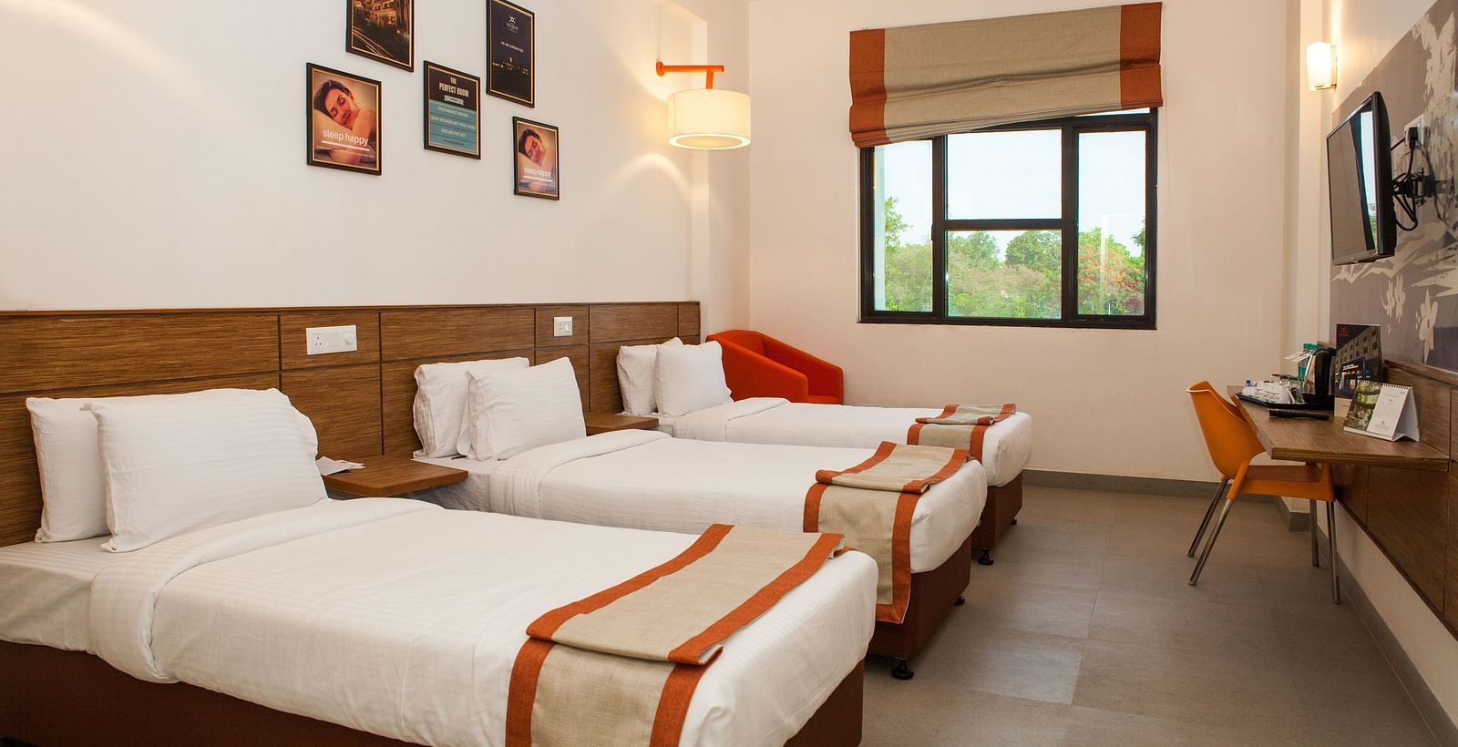 a room with three single beds and a window at the far end of the room - Max Hotel Jabalpur