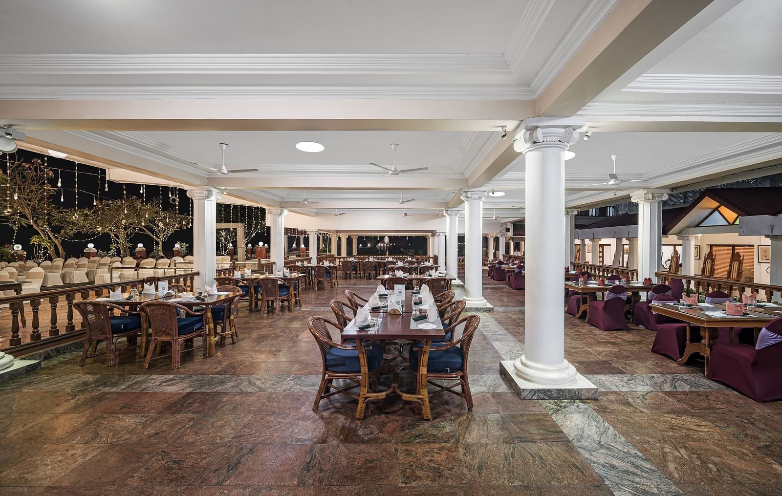 Night shot of Dhanyam with seating arrangement which is brightly lit - GReaT Trails River View Resort Thanjavur By GRT Hotels