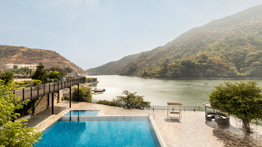 A swimming pool with a view of a lake and mountains - Via Lakhela Resort & Spa, Kumbhalgarh