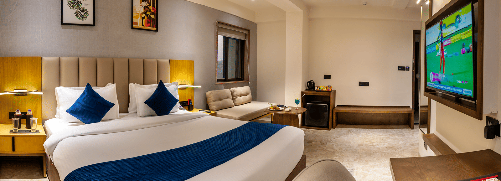 Spacious accommodation with king bed, seating area, and modern interiors at Lords Studio Inn, Jamnagar.