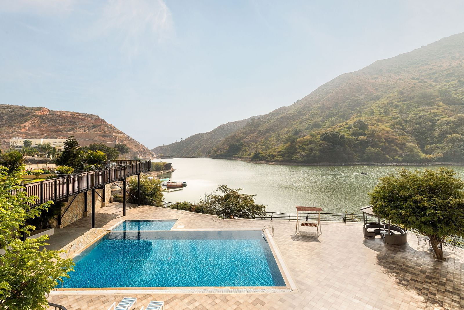 A swimming pool with a view of a lake and mountains - Via Lakhela Resort & Spa, Kumbhalgarh