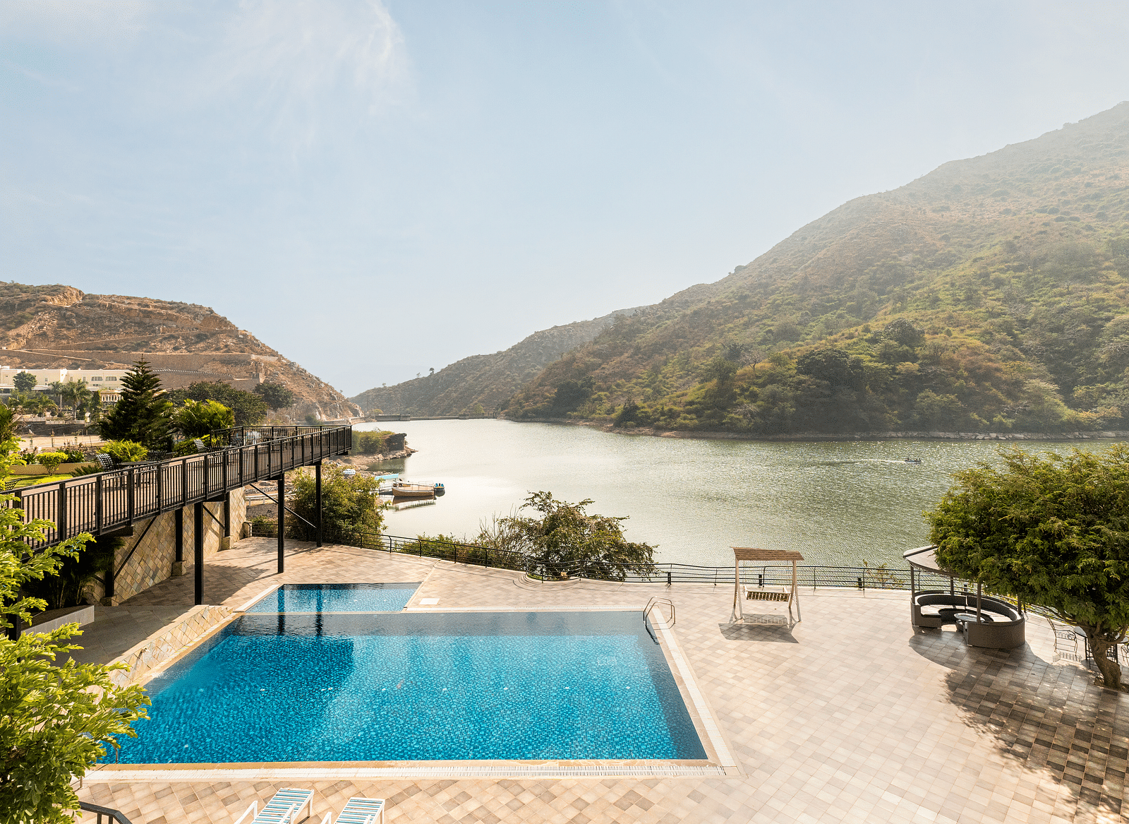 A swimming pool with a view of a lake and mountains - Via Lakhela Resort & Spa, Kumbhalgarh
