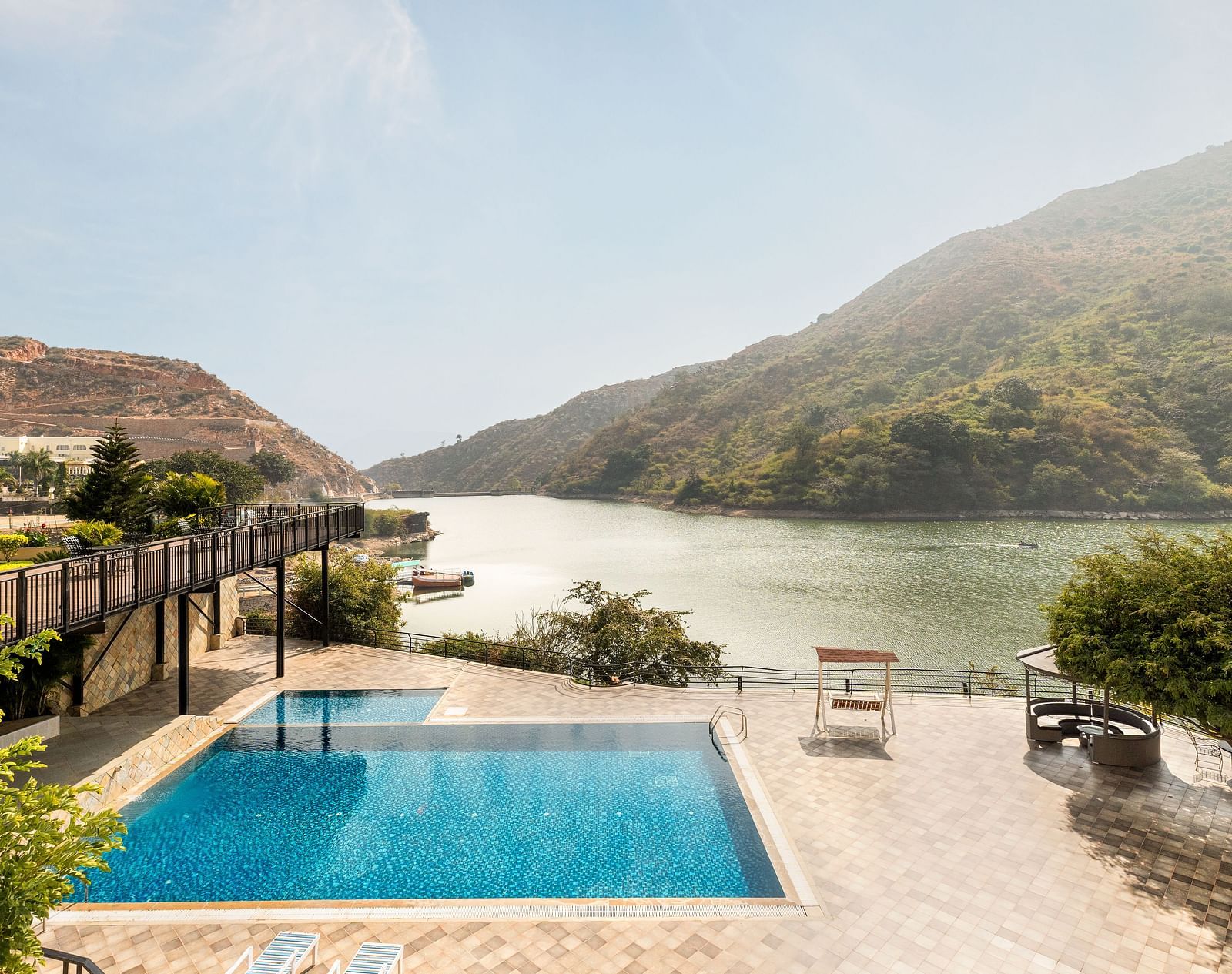 A swimming pool with a view of a lake and mountains - Via Lakhela Resort & Spa, Kumbhalgarh