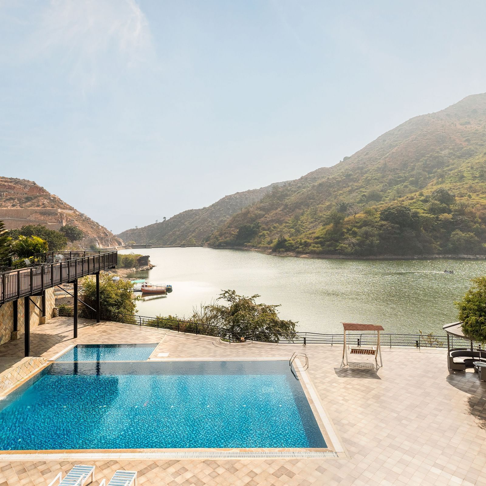 A swimming pool with a view of a lake and mountains - Via Lakhela Resort & Spa, Kumbhalgarh