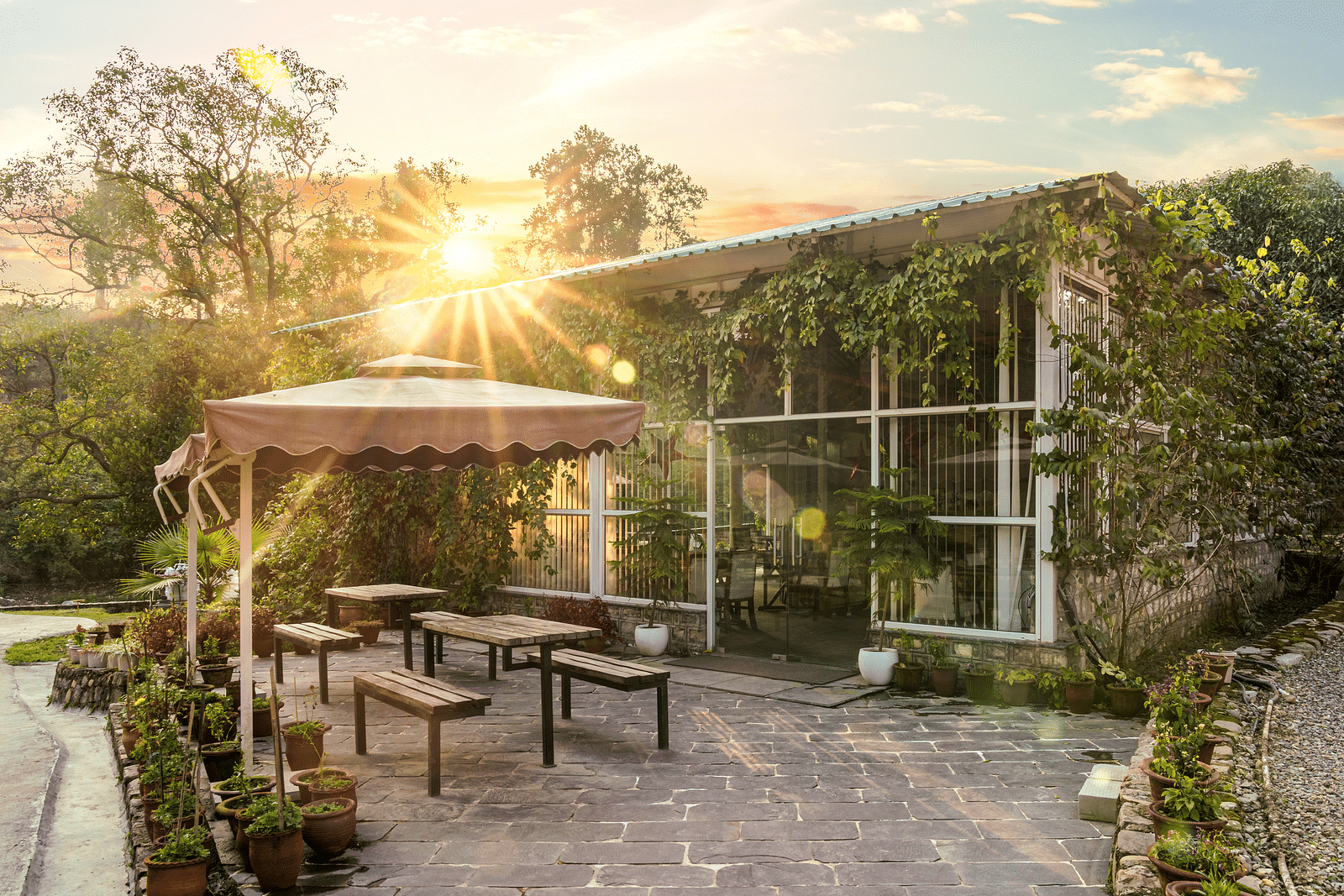 An open dining setting at Bread and Brook at the Sylvan Retreat, Dehradun.