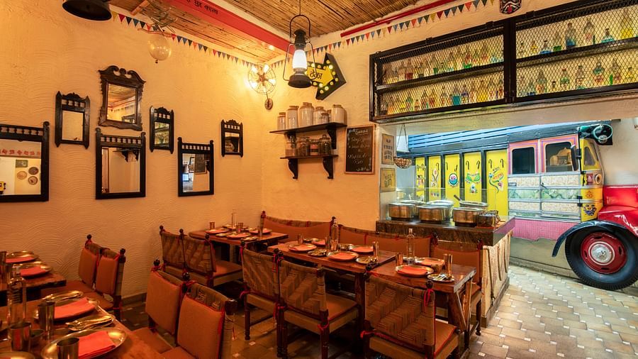 Image featuring the Dhaba dining area at The Claridges New Delhi, showcasing an authentic vintage-inspired decor with rustic seating and hanging antique lamps