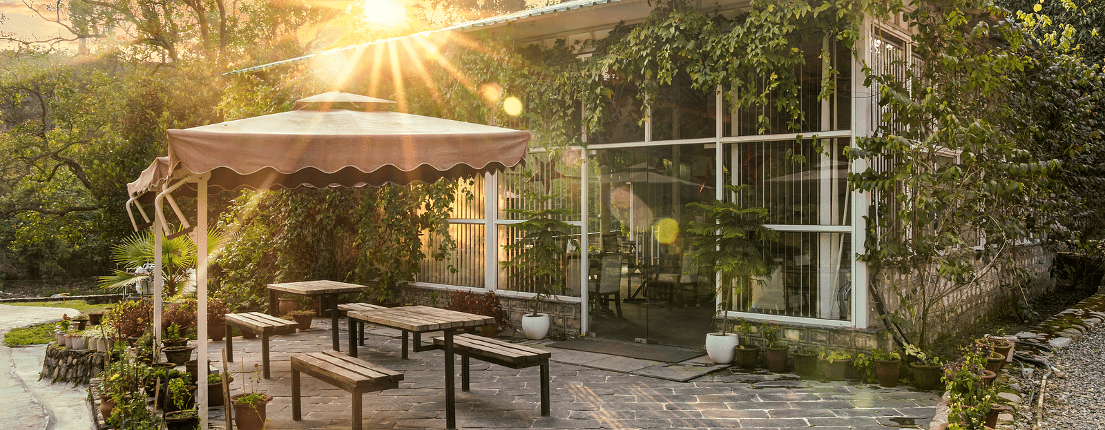 An open dining setting at Bread and Brook at the Sylvan Retreat, Dehradun.