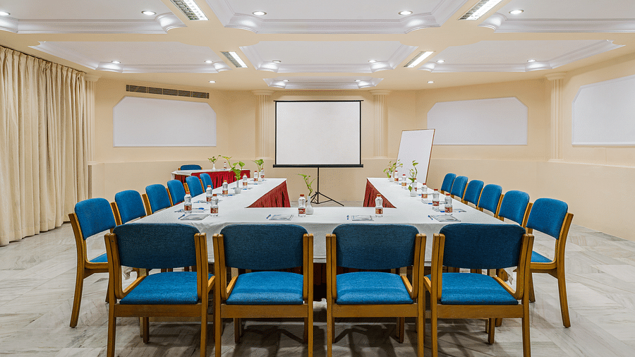 An overview of the Conference hall with U shaped table and blue chairs in view - - Hotel Rajdarshan, Udaipur.