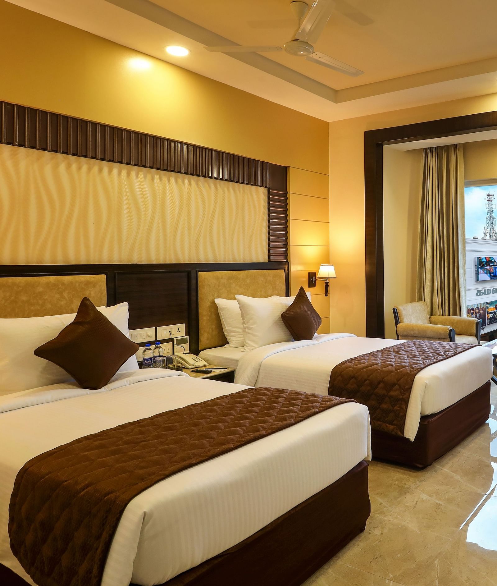 Brightly lit spacious Deluxe Twin Room with an attached balcony at Hotel Aadithya, Chennai