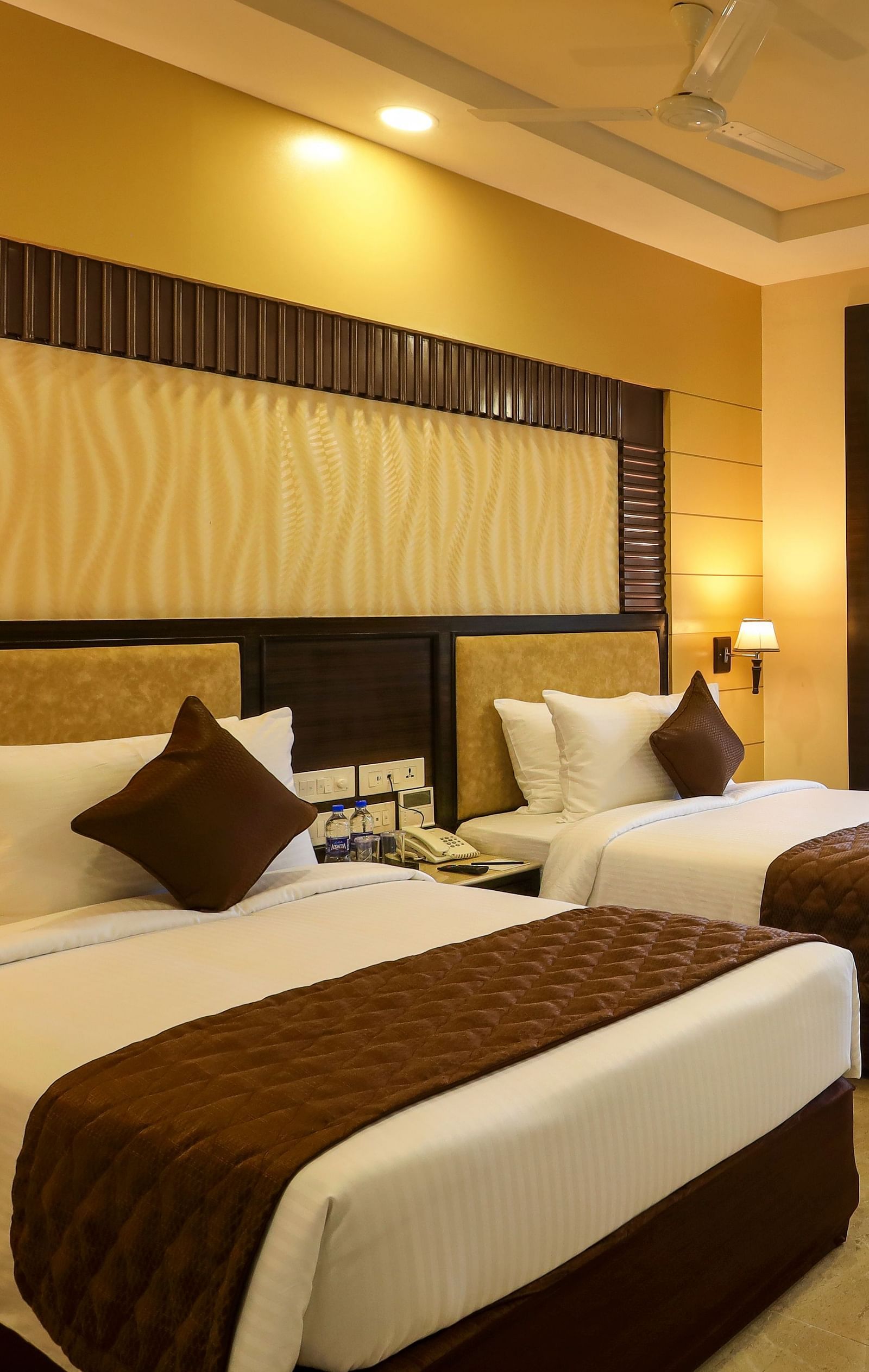 Brightly lit spacious Deluxe Twin Room with an attached balcony at Hotel Aadithya, Chennai