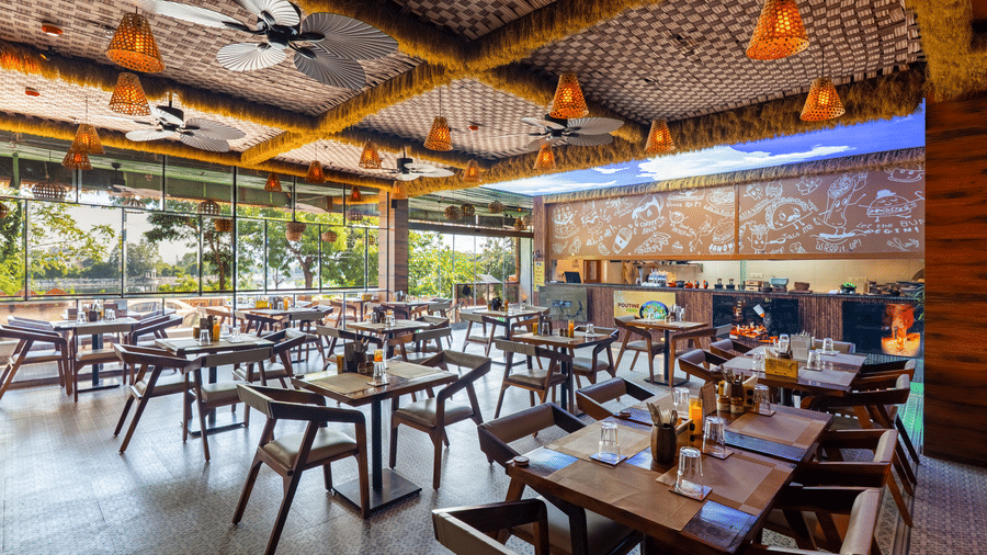 The setting combines natural wood furniture with unique ceiling fixtures and an airy, spacious feel.