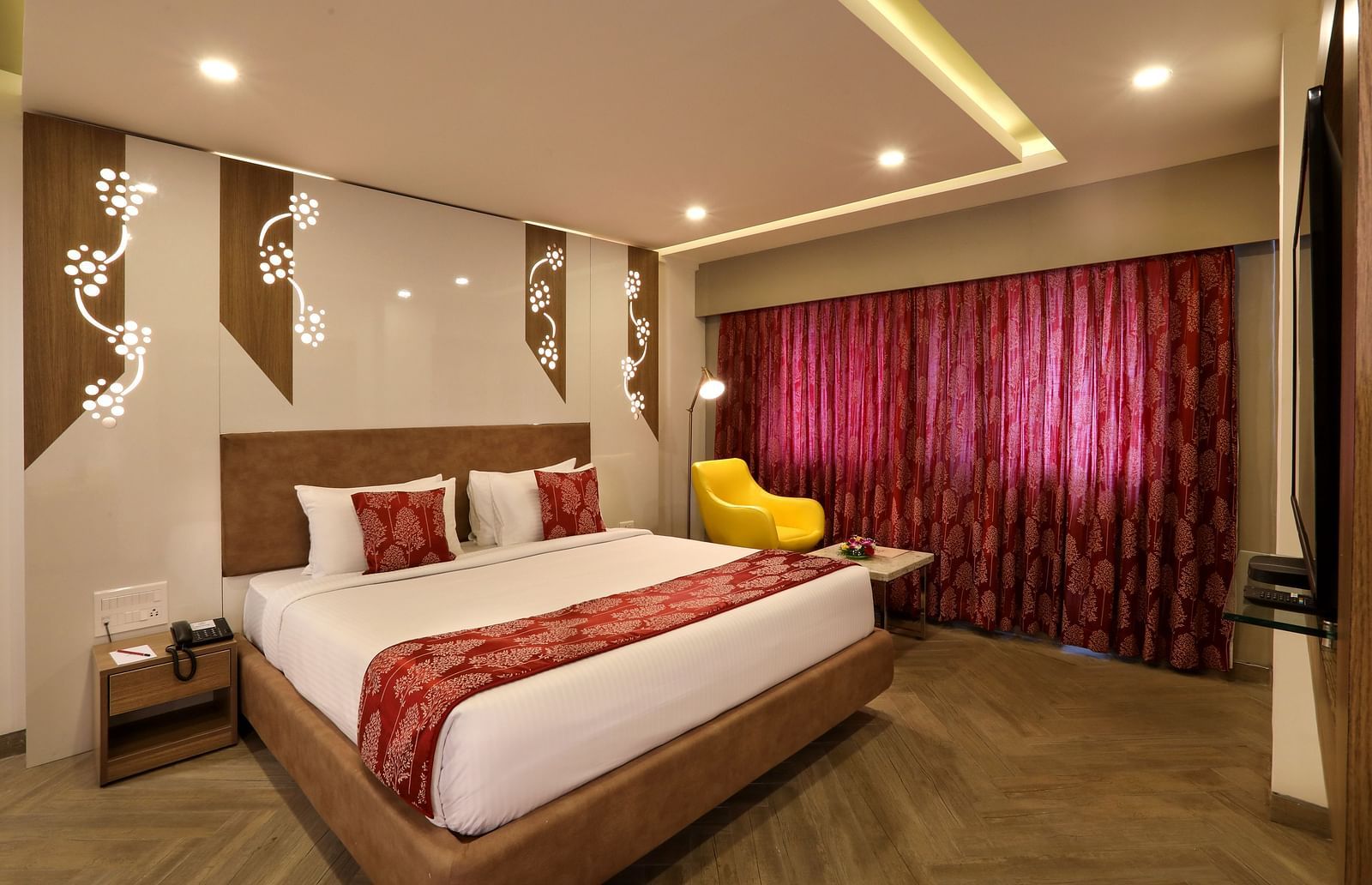 Chic hotel room with king-size bed, plush headboard, and curtains  | Mango Hill Central, Chennai