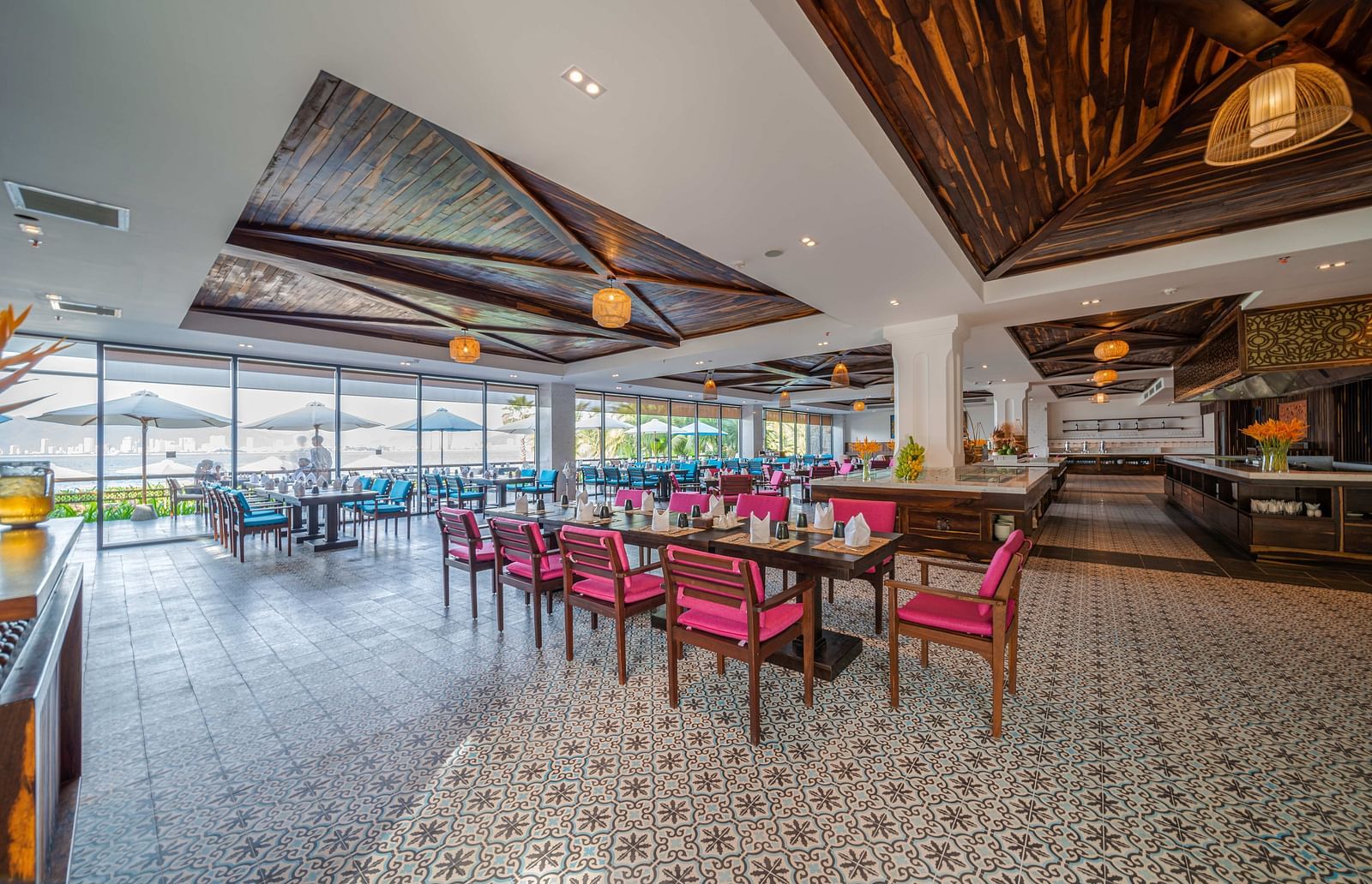 Another view of the Sea Restaurant with maroon coloured chairs and lamps hanging from the ceiling - Alibu Resort Nha Trang