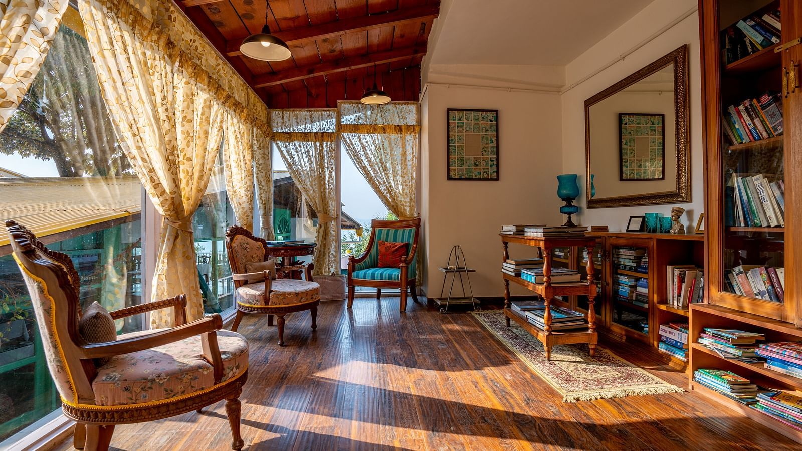 An open area with wooden shelves and books at Te Aroha By Shervani, Mukteshwar