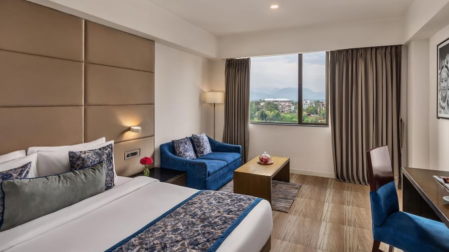 Guest room with large window and twin beds at Voyage Milestone Hotel and Banquet.