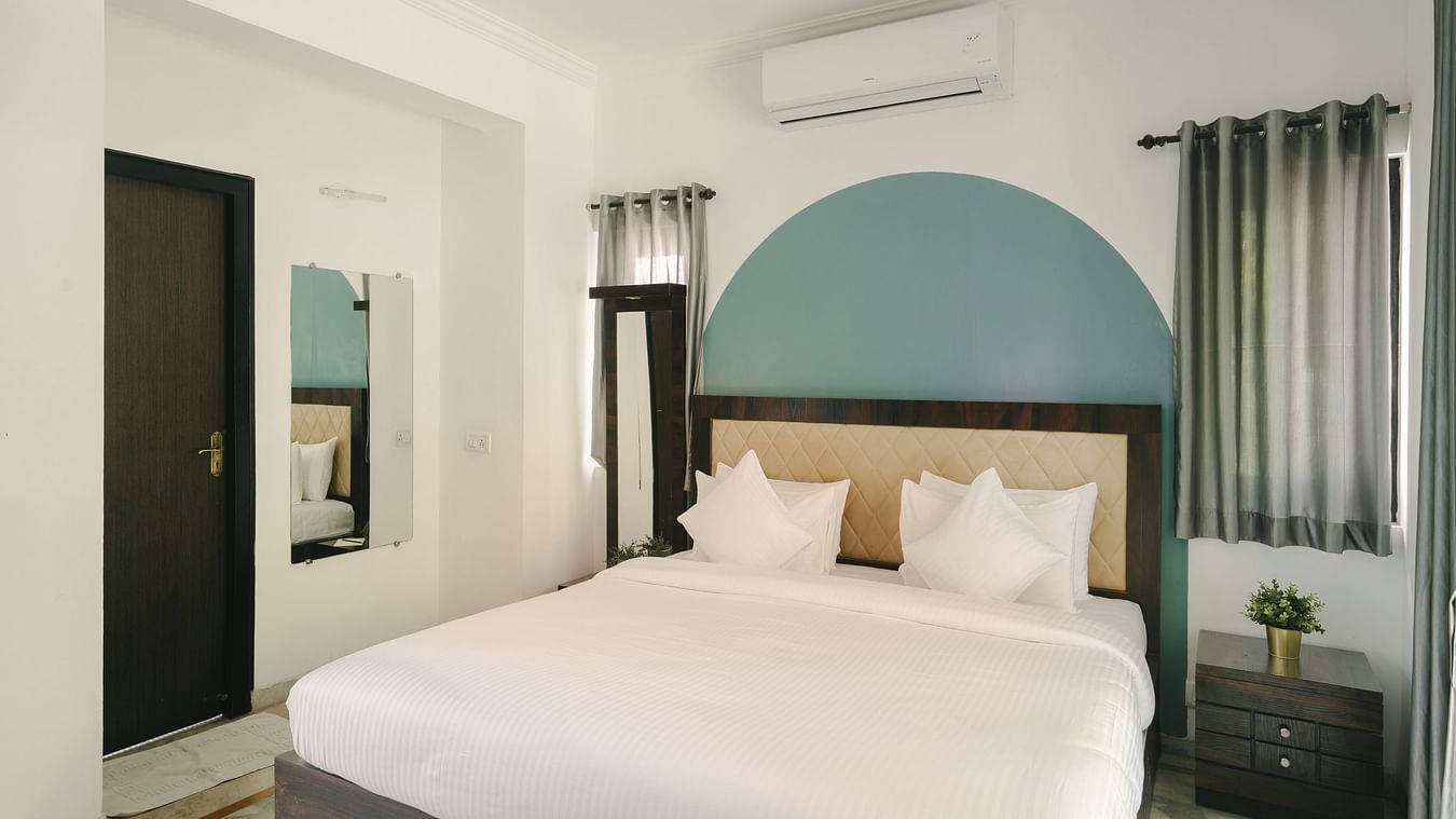 Spacious bedroom with a plush king-sized bed in the Three BHK Deluxe Villa at Richmonde Ananta Elite, Goa.