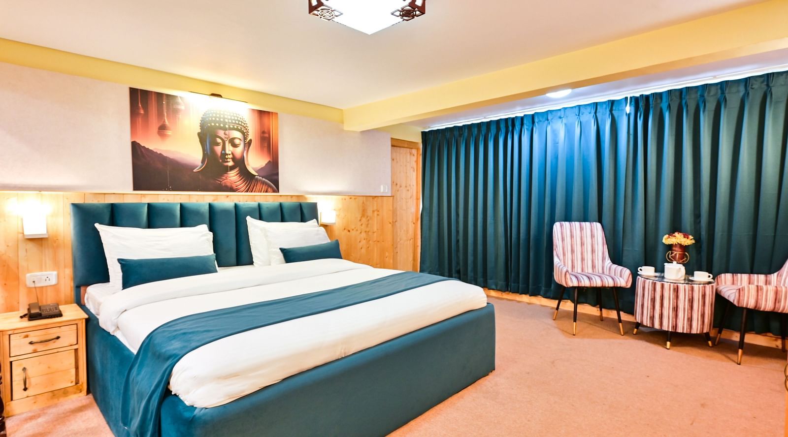 Premium room featuring a king sized bed, wall mounted television, windows with curtains, and warm lighting at Avianna Seven Seas, Darjeeling16