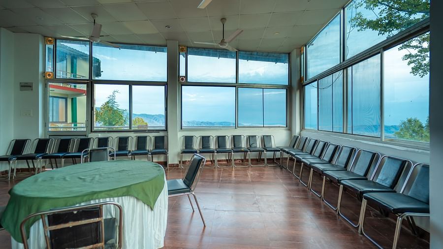Banquet at Flutter Hotels and Resorts with round table, aligned chairs and glass windows overlooking the valleys.
