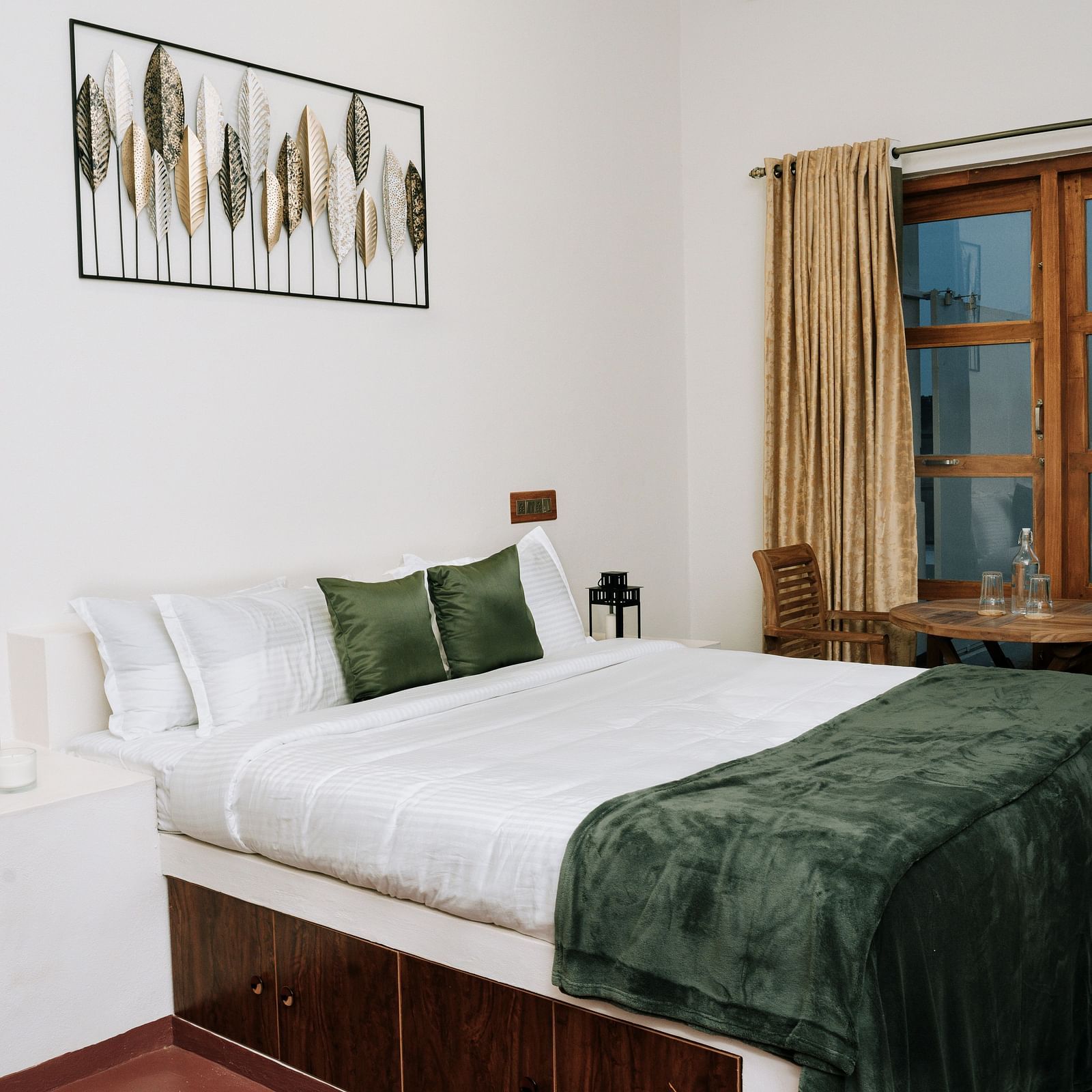 A bed in a room that has a glass window | Habba Dates Villa, Hampasandra