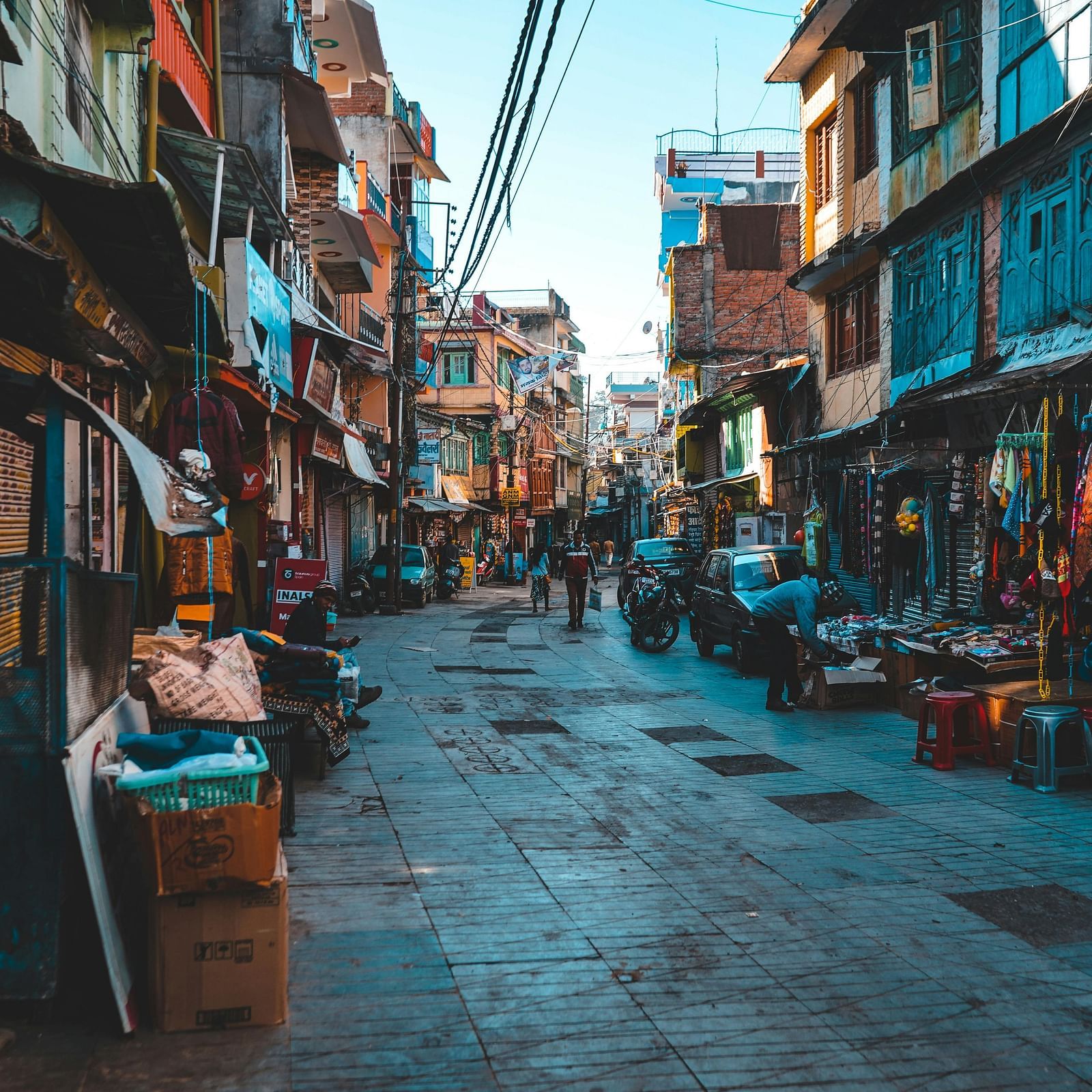 People walking on the street in a market during the day.