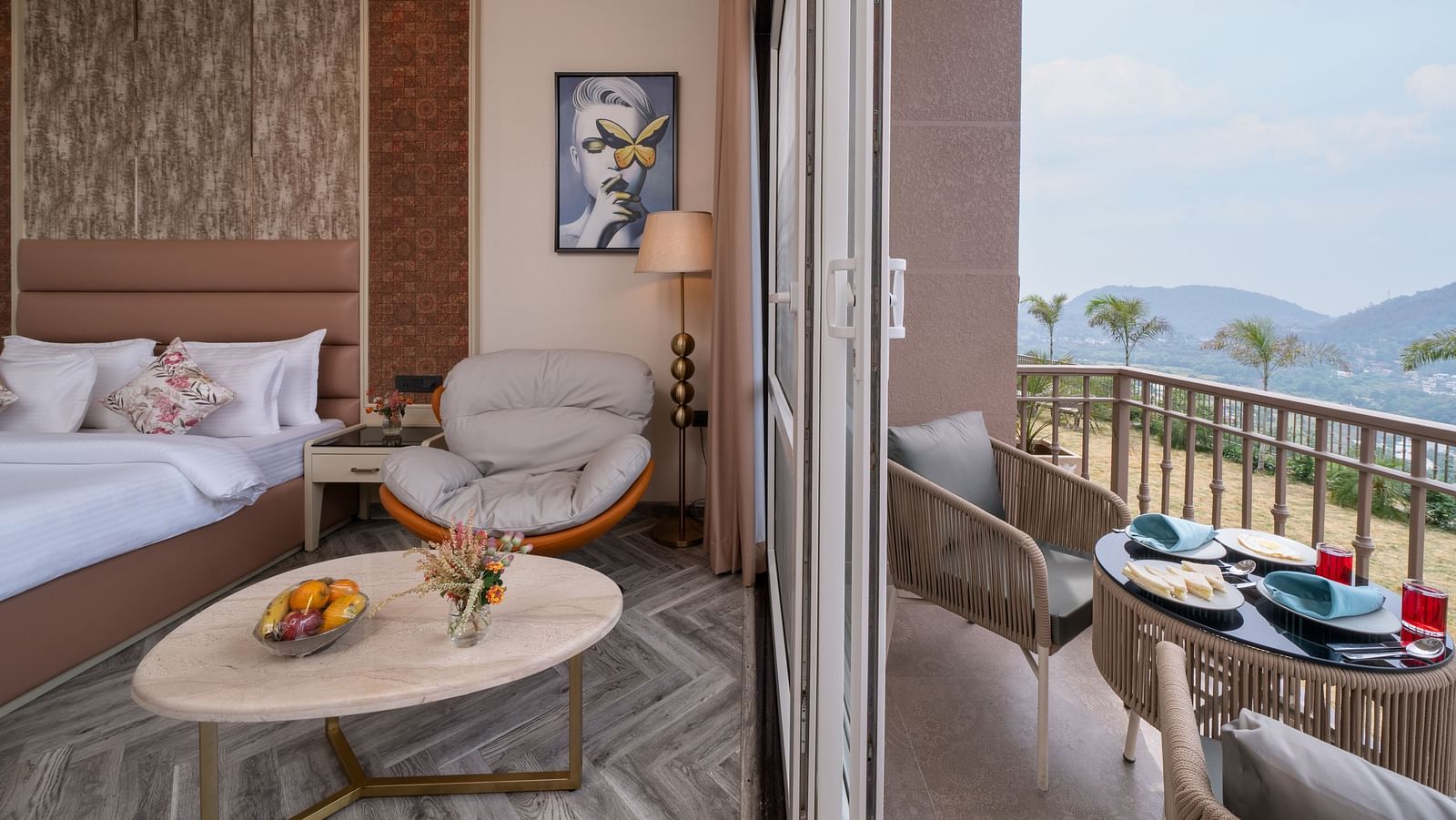 an image of a bedroom on one side with a single sofa and next to the room is a balcony with a seating arrangement -  Mountoria Retreat, Naukuchiatal
